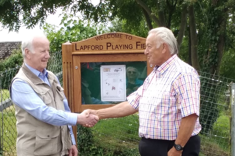 Derek Parrot, left, who designed and made the new sign at Lapford Playing Field is thanked by the Playing Field Trust Chairman Roy Andrews.
