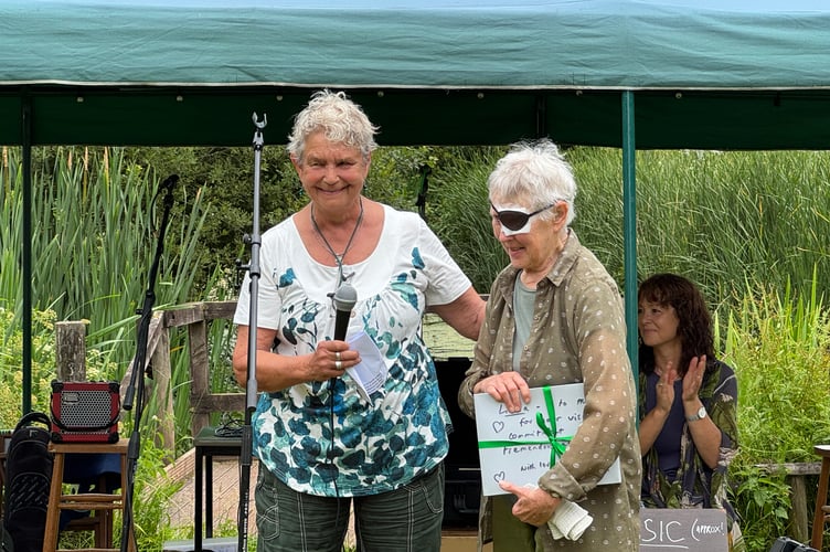 Penny Somerville, left, presenting the gift to Green benefactor and one of the founders, Linda Lever, who is emigrating.  AQ 4665
