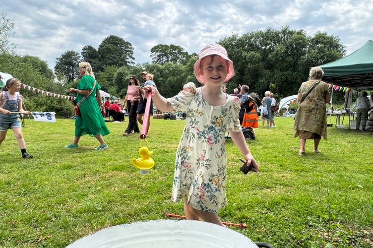 Hook a duck was a favourite game for youngsters at Sandford Millennium Green Party. AQ 4692
