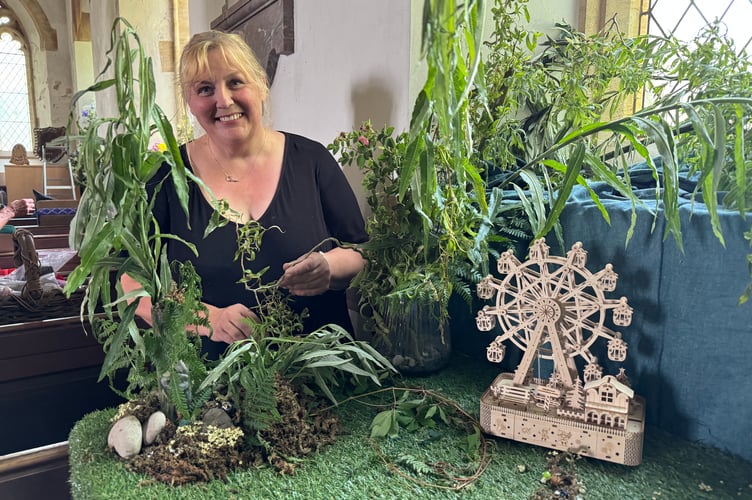 Sally Hurst part way through creating her display entitled ‘The Enchanted Garden’.  AQ 4529