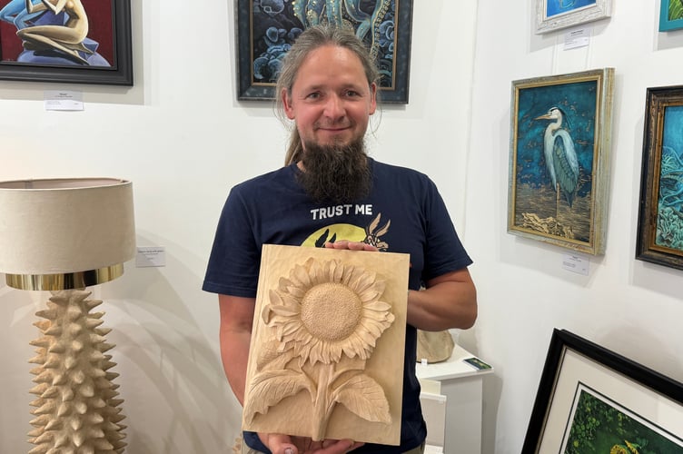 Tom Pawinski with one of his carvings.  AQ 4593
