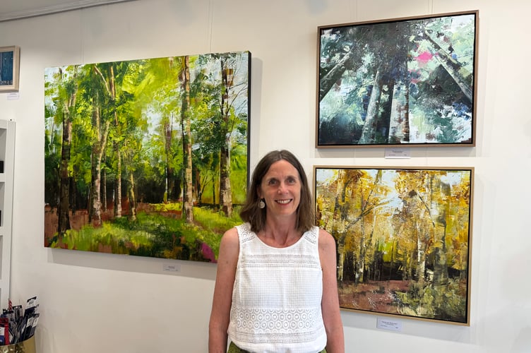 Belinda Raynell, with some of her art on display at Art Plus Frames.  AQ 4579
