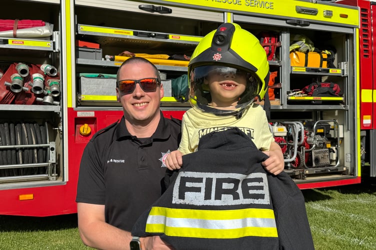 Dressing up as a firefighter was fun at the fete. AQ 5143