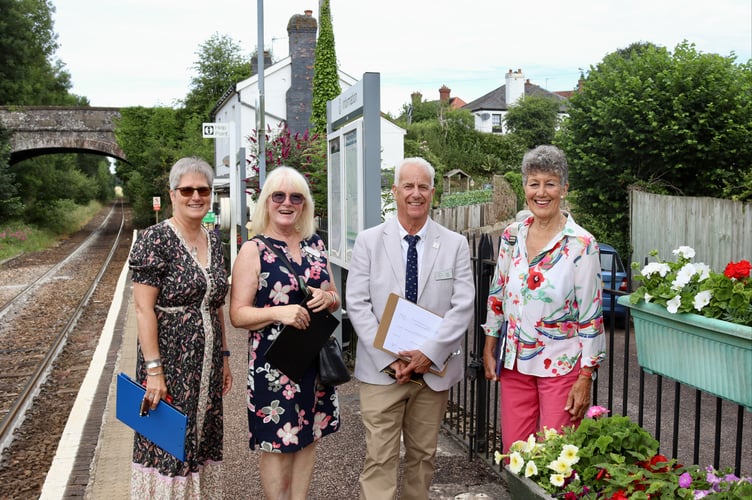 Julie Furniss, left, and Christine Fraser, right, of Newton St Cyres in Bloom with South West in Bloom judges Barbara Hannan and Bob Ollier at Newton St Cyres railway station