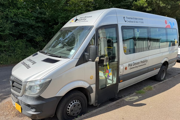 The accessible minibus parked in Commonmarsh Lane, Crediton, which has had three tyres stabbed.  AQ 5741
