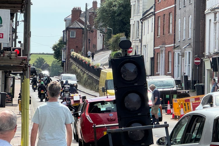 The motorcycle escort travelling along the A377 from Crediton High Street to the Devon and Exeter Crematorium. AQ 5760