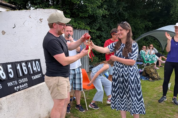 Friends of Cheriton Bishop Primary School Chair Anna Southall presented the trophy and mascot to Captain Edd Willoughby.
