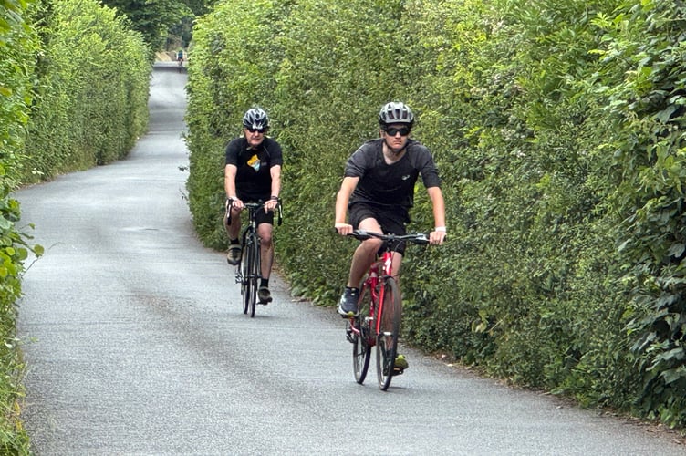 On Higher Road in Crediton, cyclists taking part in the Nello. AQ 5322