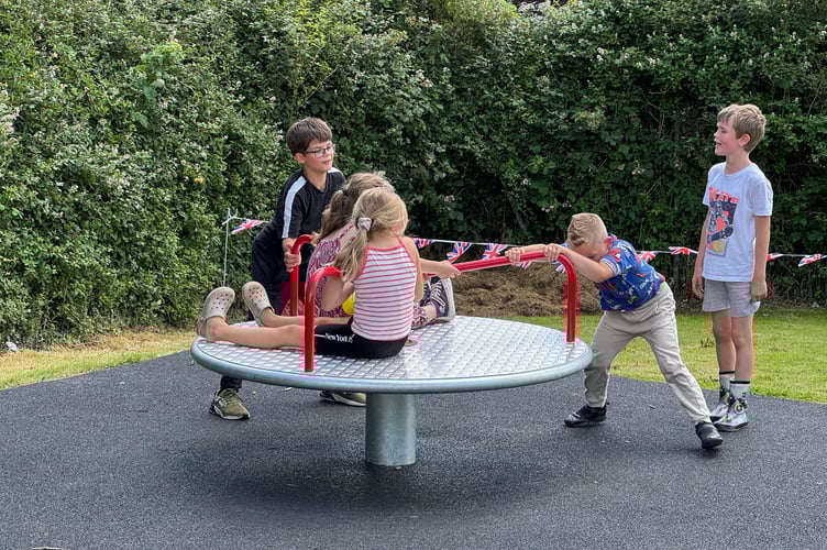 Children on one of the new items of play equipment at Lapford. AQ 5274