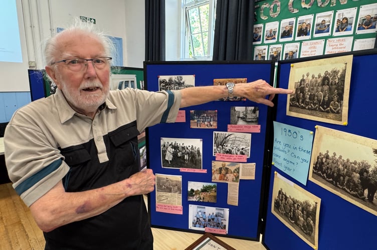 Bob Wright pointing to an image of himself in a 1950’s photo of his class at Sandford School. AQ 5495