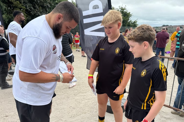 Signing autographs for young rugby fans at Crediton Rugby Club. AQ 5949