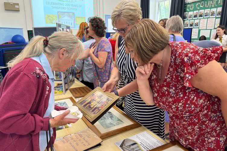Looking at old photos at Sandford School 200th birthday.  AQ 5559
