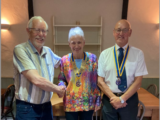Fred Oliver, left, hands over the Presidency of Crediton Boniface Rotary Club, with new vice president Paul Fallon, right.
