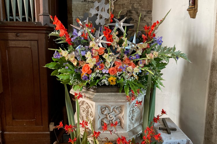 Industrial-themed floral display inside St Thomas of Canterbury Church