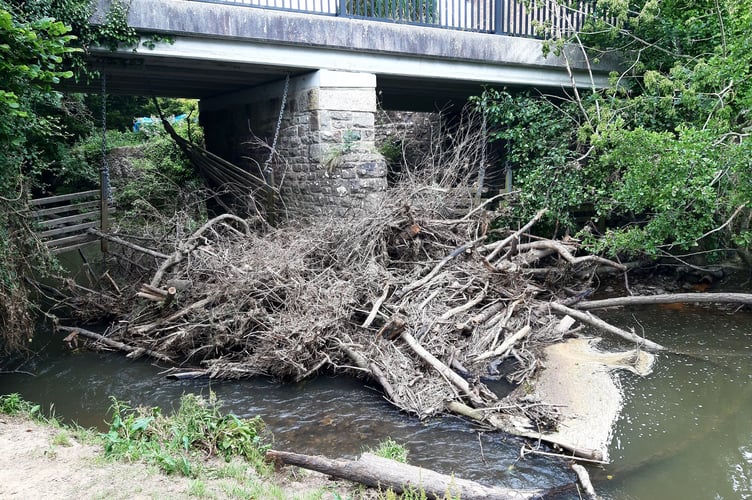 The debris and trees against the bridge at Gunstone.
