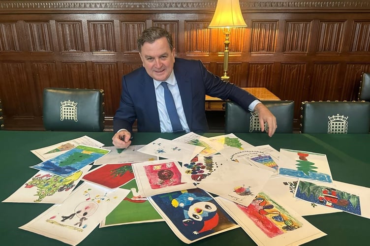 Mel Stride with entries from his annual Christmas Card competition