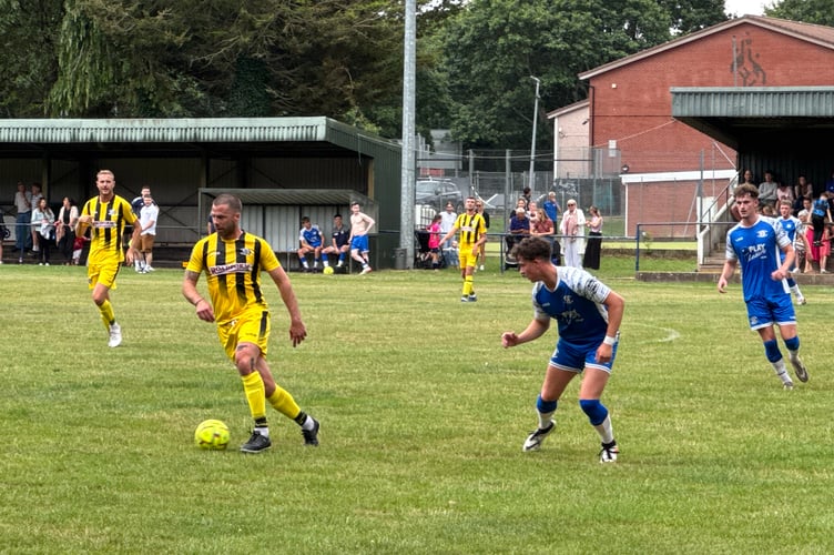 A Dave Lee XI player in possession during the Testimonial game v Crediton United. AQ 7135