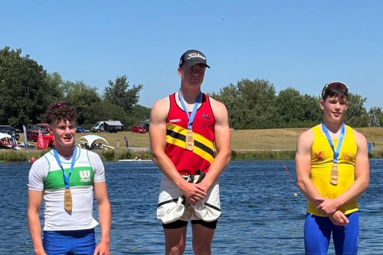 Freddie Heard, centre, on podium after winning U16 1000m at National Championships