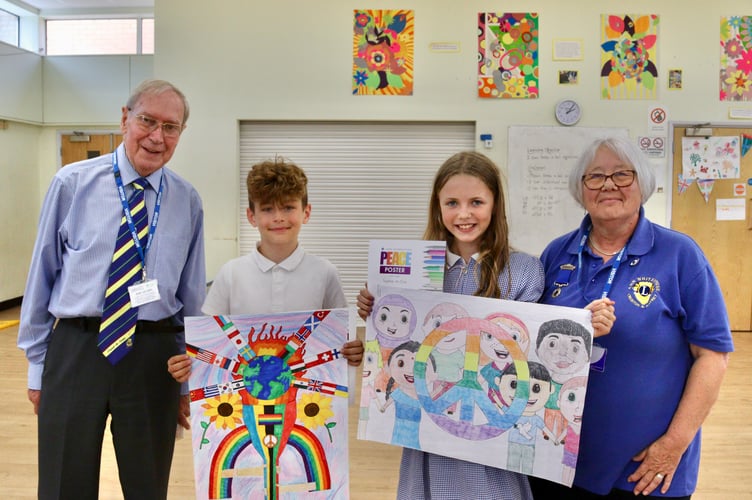 Landscore peace poster winner Lilah Wyn Pugh and runner-up Freddie Hubber with Eric Parkes and Ann Whitehouse of Crediton Lions Club.