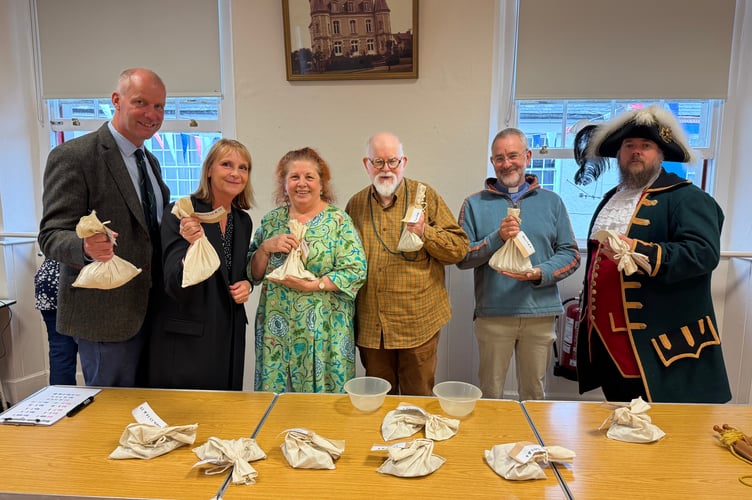 Ready to throw coins out of the Town Hall windows for the money scramble, from left, Michael Johnson, Laetitia Johnson, Deborah Phillips, Ed Phillips, Tony Rockey from Little Dart Mission Community and Town Crier Ben Farlam. AQ 7299