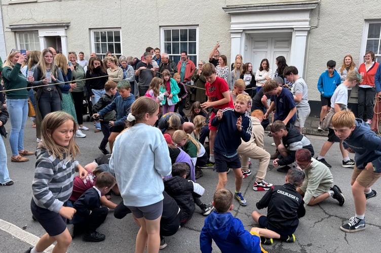 Children taking part in the traditional money scramble at Chulmleigh Fair. AQ 7341