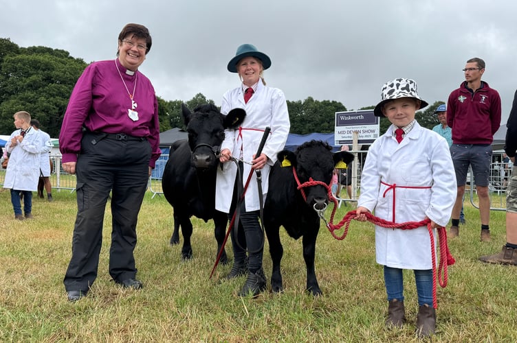 The Bishop of Crediton, the Venerable Moira Astin, met Amy Hamlett and her son, William (6) from Fire Beacon Farm, Tiverton, with their prize-winning Dexter cow Laurel and her calf of five months, named Happy Cheese.  AQ 7531
