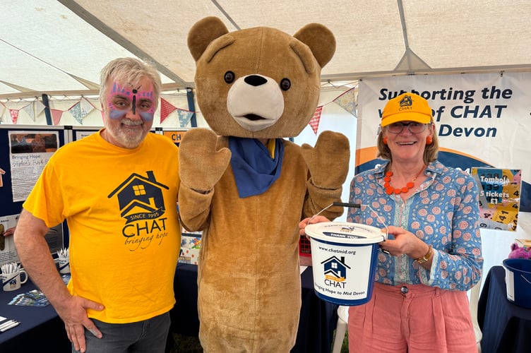 Pete Bangs, left and Penelope Blackwell, from CHAT, the Christian Housing Action Team are pictured with Charlie the CHAT bear at the Mid Devon Show. AQ 7623