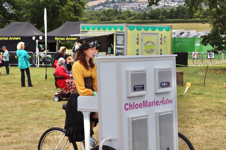 Chloe Marie Aston with her piano tricycle