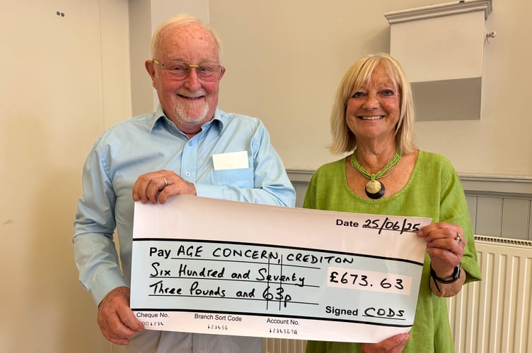 John Musty receives a cheque for Age Concern Crediton from CODS President Carolyn Stoyle.  AQ 5015
