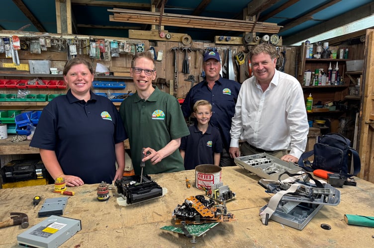 Mel Stride MP, right, during his visit to Lindfield Day Opportunities with, from left, deputy manager Becky, service user Jack, Nicholas (9) and Kevin Cozens, manager. AQ 7049