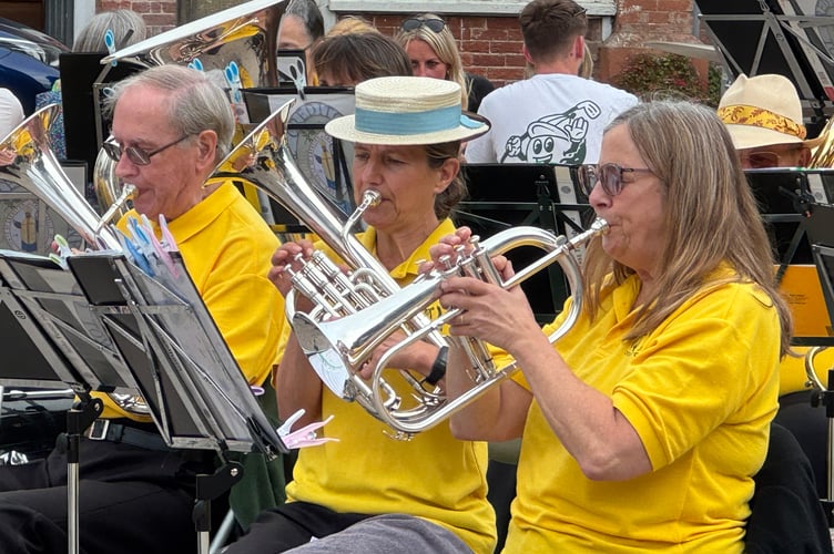 Some of the members of Crediton Town Band during a recent concert in Crediton Town Square. AQ 5158