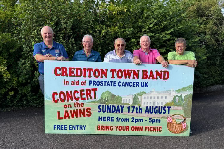 The sign advertising Crediton Town Band Free Concert with Mike Palmer who painted it second left, with those who put up the sign at Downes, the wood kindly provided by CMC Eakers.  AQ 7922
