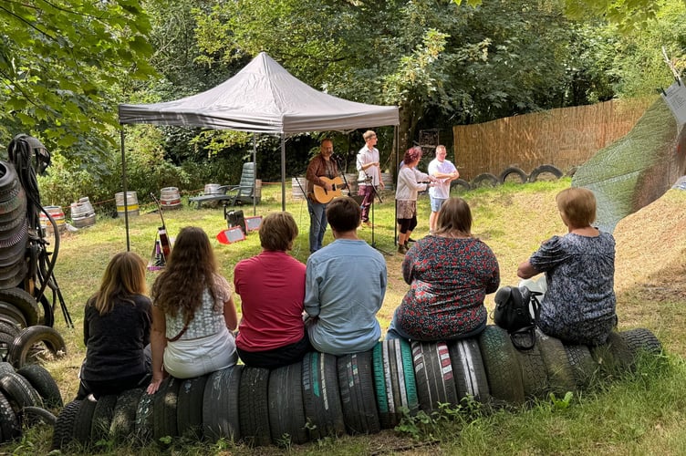 Tony Miller and some of the Turning Tides members performing at Four Mills Garden as part of Crediton Heart Project’s Summer Arts Festival. AQ 8034