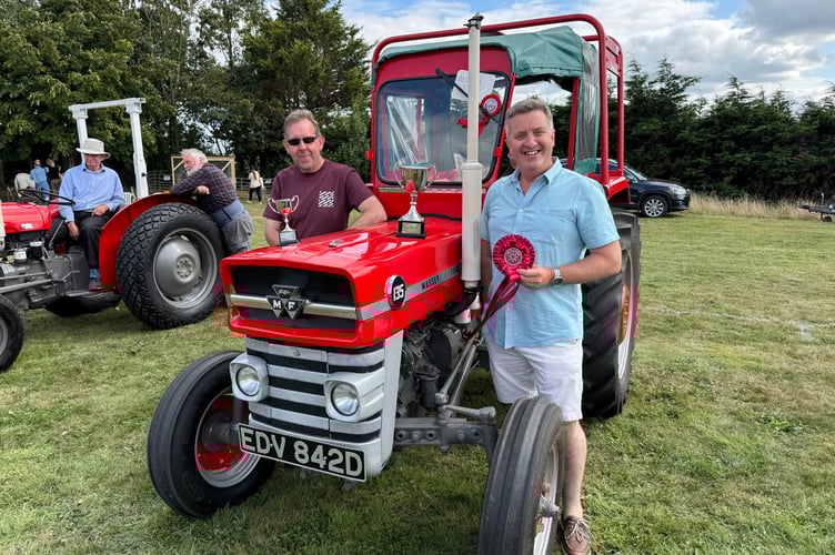 Andrew Rice, right, of Morchard Bishop with his Massey Ferguson 135 tractor, judged champion in the Vintage section at Morchard Bishop Vintage Rally with Wesley Powell, left, who helped him restore the tractor.  AQ 8287
