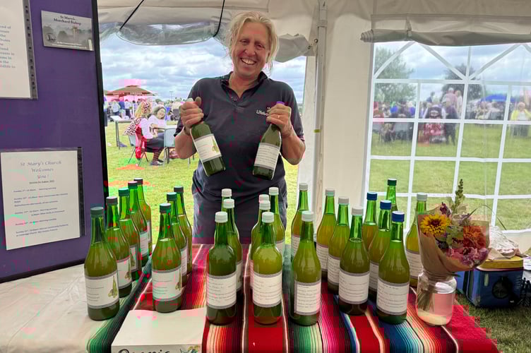 Wendy Vere sold organic apple juice at Morchard Bishop Family Fun Day. AQ 8154