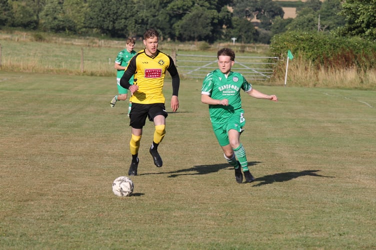 A Sandford player, right, went on to win the ball against an Exmouth Riptide player.  AQ 0757
