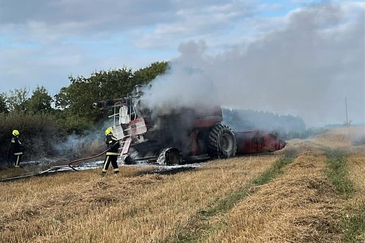 Firefighters putting out the combine harvester blaze.
