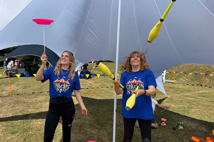 Olive and Abi from Higher Beings Circus helped people learn to spin plates and juggle at Arts in the Park. AQ 8864