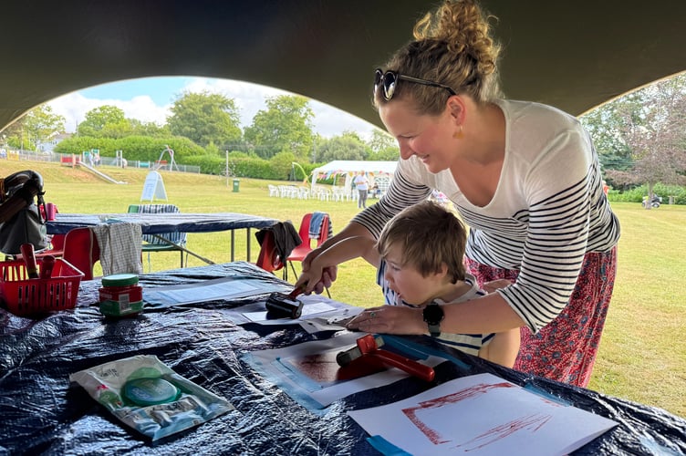 Having a go at print-making at Arts in the Park. AQ 8828