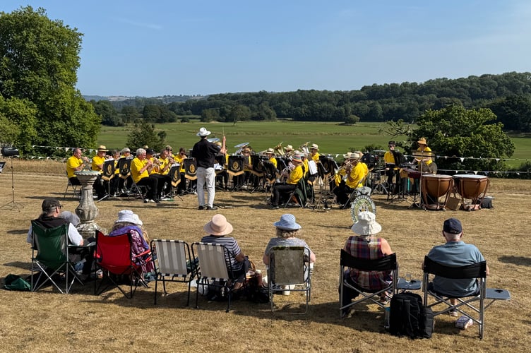 Some of the public seated on the lawn to watch Crediton Town Band play at Downes. AQ 0727