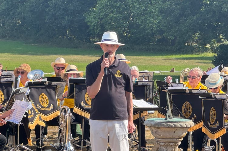 Crediton Town Band musical director, Iorwerth Pugh introducing the next tune. AQ 0748