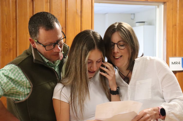 Lottie Jackson gained 10 GCSEs, 6 of these grades were the highest, Grade 9, pictured with her parents.