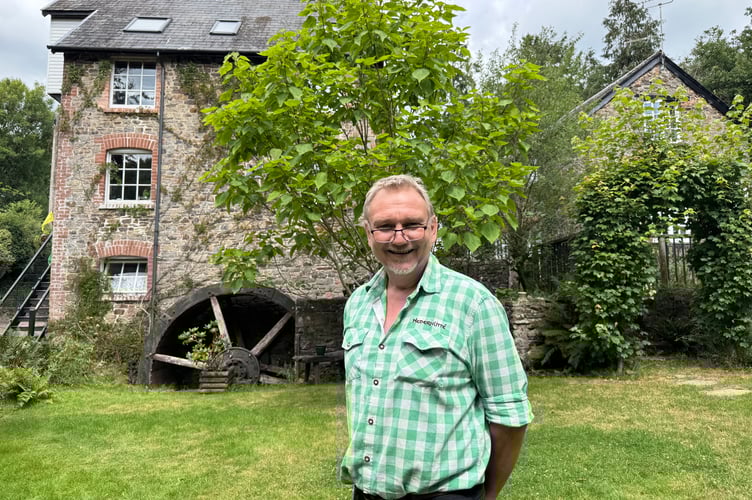 Alex Gater, proprietor, in front of Lapford Mill. AQ 8113
