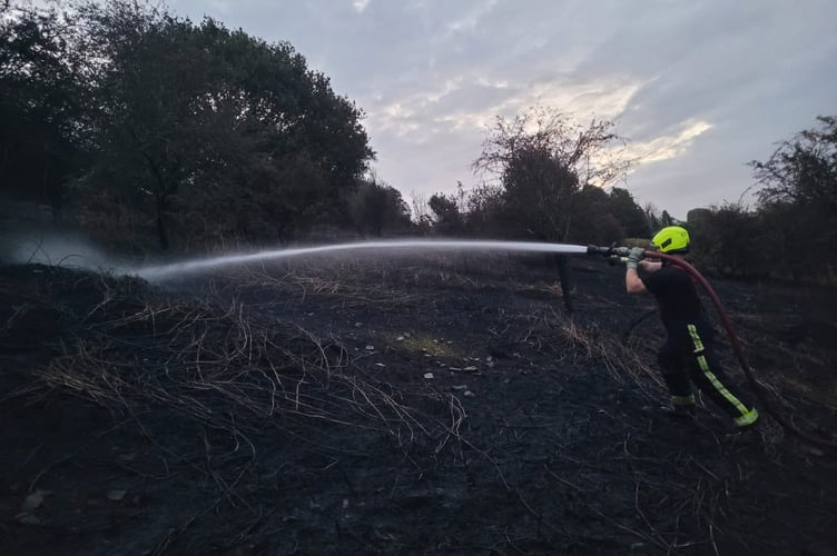 A North Tawton firefighter damping down at Torrington Common.