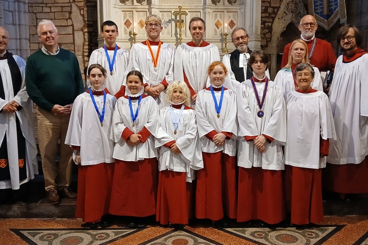 After the recent Crediton Parish Church Friends’ Evensong Service, The Very Rev Dr David Ison KCVO (former Dean of St Paul’s Cathedral), the Rector of Holy Cross, the Rev Matthew Tregenza, the seven Choral Award recipients and some of the trustees of Crediton Church Music Endowment Fund.
