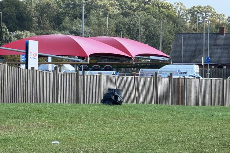 Some of the rubbish left behind on the grassed areas at the back of the Crediton Tesco superstore.  AQ 3065
