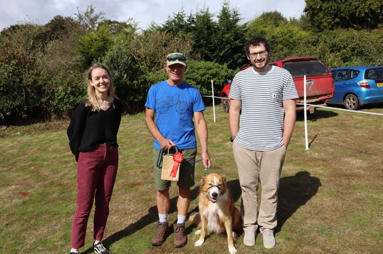 Dog show judges Annelie Coetzer of Vets for Pets, left, and Matthew Woods of Ark Vets, right, chose Rob's 11-year-old Border Collie Boo as the winner of the 'most appealing eyes' class