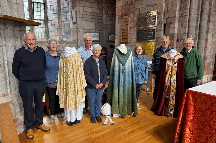 Helpers at Crediton Parish Church Heritage Open Day beside some of the copes on display.  AQ 2797
