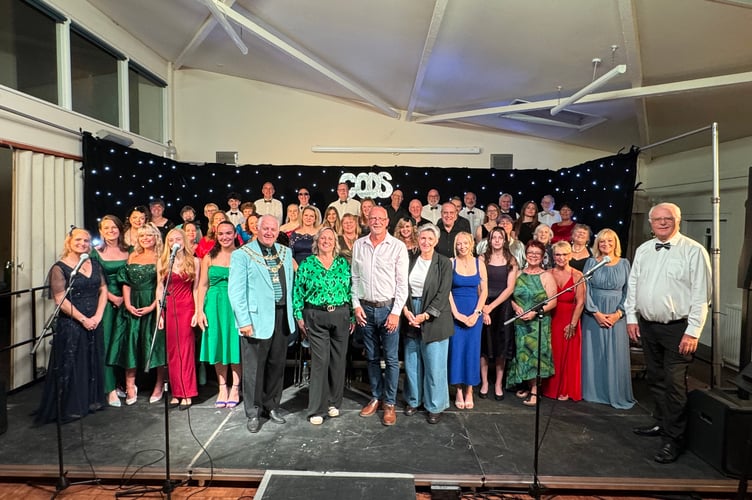 The CODS singers with the National Operatic and Dramatic Association President Graham Liverton, CODS chair Holly Harris, sponsor Paul Steer and Mrs Steer and right, Mike Canning, Musical Director. AQ 3500