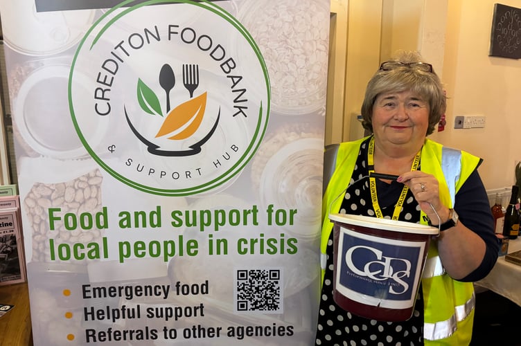 Hazel Evely, Morrisons Community Champion, helped by accepting donations for Crediton Foodbank as audience members left the 80’s evenings.  AQ 3514

